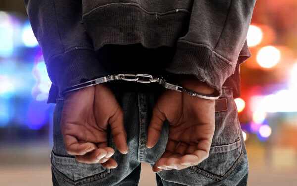Man, 23 Arrested for Hacking Girlfriend 44 to Death Suspect handcuff